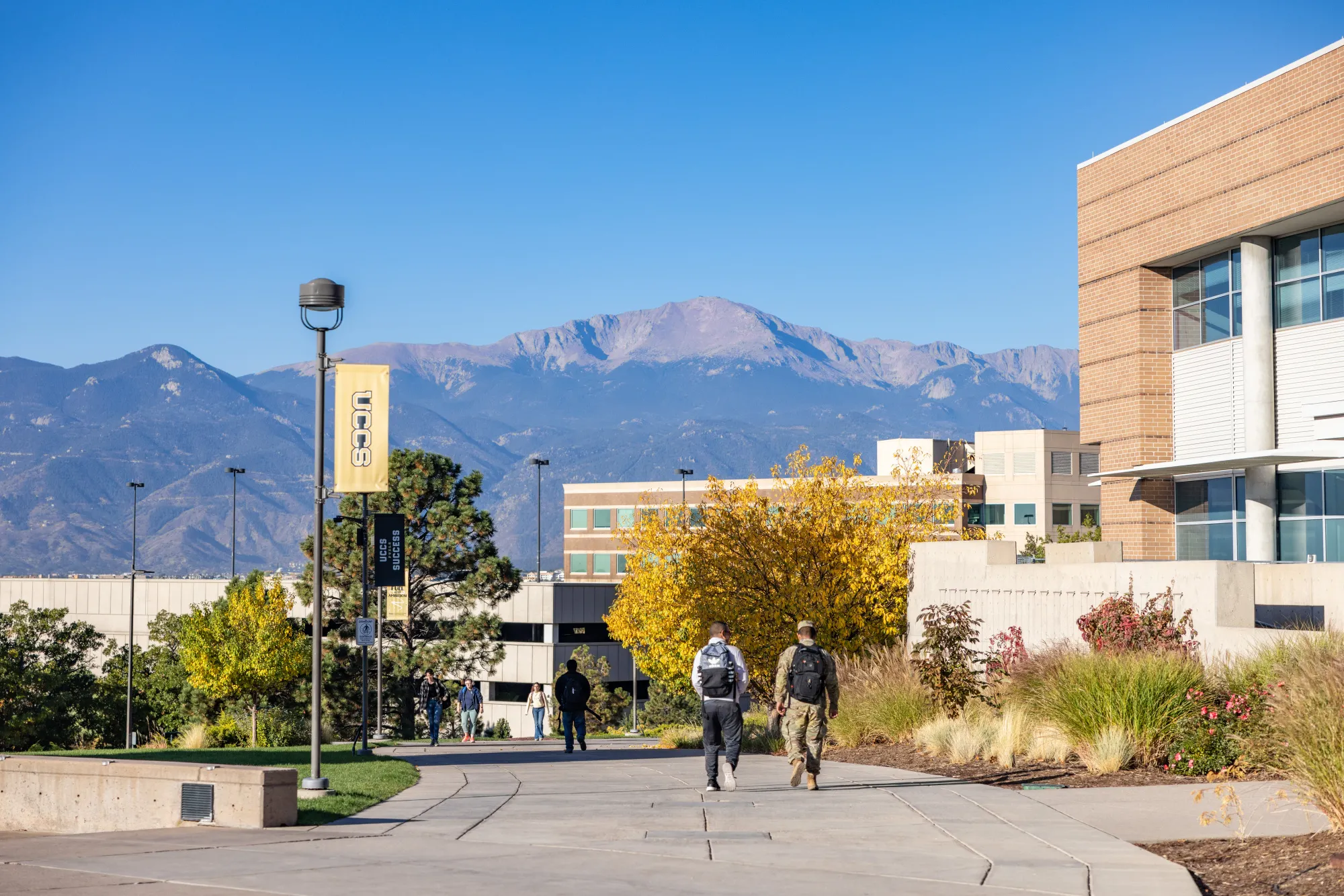 Two students walking with mouantins in the backround 